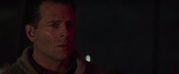 Movie still from “Die Hard 2” (1990), directed by Renny Harlin – A person looking at the camera; Close Up shot, Low angle