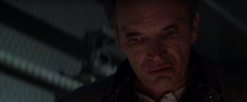 Movie still from “Die Hard 2” (1990), directed by Renny Harlin – A person looking at the camera; Close Up shot, Low angle