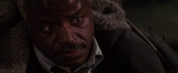 Movie still from “Die Hard 2” (1990), directed by Renny Harlin – A man's face in a dark room; Close Up shot, Low angle