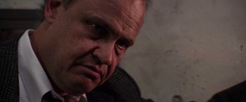 Movie still from “Die Hard 2” (1990), directed by Renny Harlin – A man's face as he stares into the distance; Close Up shot, Low angle