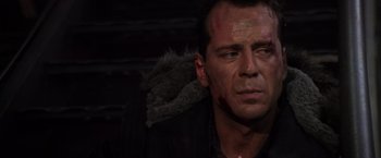 Movie still from “Die Hard 2” (1990), directed by Renny Harlin – A person wearing a black jacket; Close Up shot, Over the shoulder angle