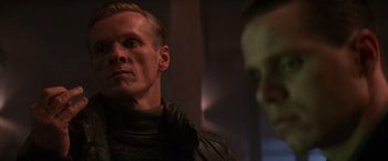 Movie still from “Die Hard 2” (1990), directed by Renny Harlin – A person in a room near a wall; Close Up shot, Low angle