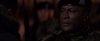 Movie still from “Die Hard 2” (1990), directed by Renny Harlin – A person wearing a hat; Close Up shot, Over the shoulder angle