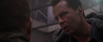 Movie still from “Die Hard 2” (1990), directed by Renny Harlin – A person looking at something; Close Up shot, Over the shoulder angle