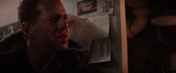 Movie still from “Die Hard 2” (1990), directed by Renny Harlin – A person in a dark room; Close Up shot, Over the shoulder angle