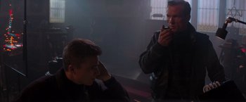 Movie still from “Die Hard 2” (1990), directed by Renny Harlin – Two men are sitting in a dark room; Close Up shot, Low angle