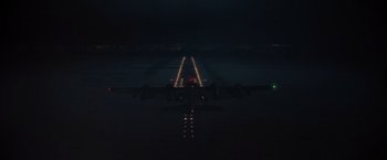 Movie still from “Die Hard 2” (1990), directed by Renny Harlin – An airport runway at night lit up by lights; Extreme Wide shot, High angle