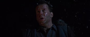 Movie still from “Die Hard 2” (1990), directed by Renny Harlin – A person wearing a shirt; Close Up shot, Low angle