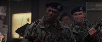 Movie still from “Die Hard 2” (1990), directed by Renny Harlin – A man in a military uniform and a hat; Close Up shot, Low angle