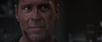 Movie still from “Die Hard 2” (1990), directed by Renny Harlin – A man's face in a dark room; Close Up shot, Over the shoulder angle