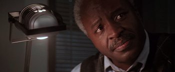 Movie still from “Die Hard 2” (1990), directed by Renny Harlin – An older man with a beard and a mustache; Close Up shot, Low angle