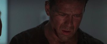 Movie still from “Die Hard 2” (1990), directed by Renny Harlin – A man's face in a dark room; Close Up shot, Low angle