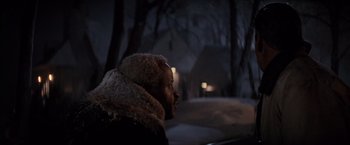 Movie still from “Die Hard 2” (1990), directed by Renny Harlin – A man in a black jacket is looking out the window; Close Up shot, Over the shoulder angle