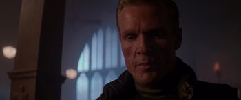 Movie still from “Die Hard 2” (1990), directed by Renny Harlin – A person wearing a sweater; Close Up shot, Low angle