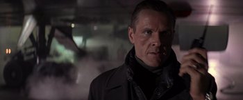 Movie still from “Die Hard 2” (1990), directed by Renny Harlin – A person wearing a jacket; Close Up shot, Low angle