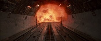 Movie still from “Die Hard 2” (1990), directed by Renny Harlin – A train tunnel with fire coming out of it; Wide shot, Low angle