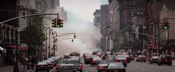 Movie still from “Die Hard with a Vengeance” (1995), directed by John McTiernan – A street filled with lots of traffic next to tall buildings; Extreme Wide shot, High angle