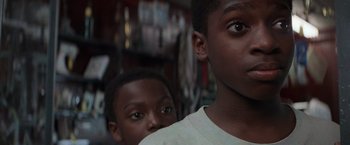 Movie still from “Die Hard with a Vengeance” (1995), directed by John McTiernan – Two young men standing next to each other in a room; Close Up shot, Low angle