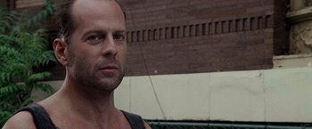 Movie still from “Die Hard with a Vengeance” (1995), directed by John McTiernan – A person wearing a tank top; Close Up shot, Low angle