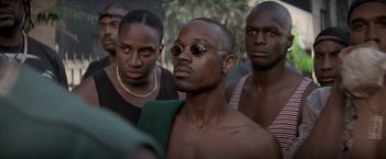 Movie still from “Die Hard with a Vengeance” (1995), directed by John McTiernan – A group of men standing next to each other; Close Up shot, Over the shoulder angle