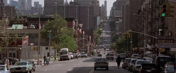 Movie still from “Die Hard with a Vengeance” (1995), directed by John McTiernan – A city street filled with lots of traffic and parked cars; Extreme Wide shot, High angle
