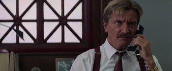 Movie still from “Die Hard with a Vengeance” (1995), directed by John McTiernan – A person wearing a suit and tie; Close Up shot, Low angle