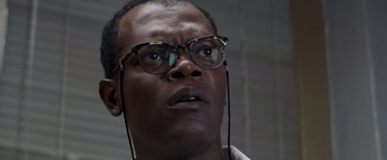 Movie still from “Die Hard with a Vengeance” (1995), directed by John McTiernan – A person wearing glasses; Close Up shot, Low angle