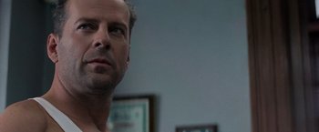 Movie still from “Die Hard with a Vengeance” (1995), directed by John McTiernan – A person looking at the camera; Close Up shot, Low angle