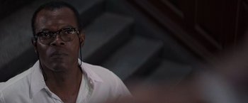 Movie still from “Die Hard with a Vengeance” (1995), directed by John McTiernan – A man wearing glasses and a white shirt; Close Up shot, Over the shoulder angle