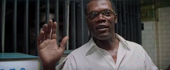 Movie still from “Die Hard with a Vengeance” (1995), directed by John McTiernan – A man in a white shirt and yellow glasses; Close Up shot, Low angle