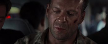 Movie still from “Die Hard with a Vengeance” (1995), directed by John McTiernan – A person with a knife in his mouth; Close Up shot, Over the shoulder angle