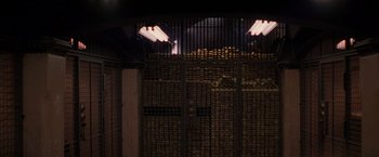 Movie still from “Die Hard with a Vengeance” (1995), directed by John McTiernan – A room filled with lots of stacks of gold coins; Extreme Wide shot, High angle