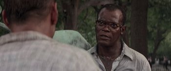 Movie still from “Die Hard with a Vengeance” (1995), directed by John McTiernan – A man with glasses is talking to another man; Close Up shot, Over the shoulder angle