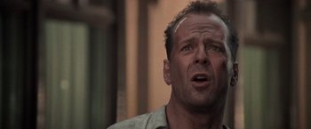 Movie still from “Die Hard with a Vengeance” (1995), directed by John McTiernan – A person wearing a shirt; Close Up shot, Low angle