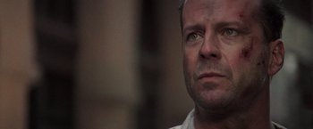 Movie still from “Die Hard with a Vengeance” (1995), directed by John McTiernan – A man's face looking up at the sky; Close Up shot, Low angle