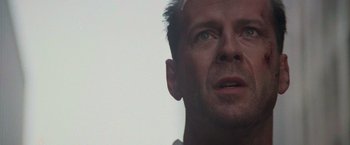 Movie still from “Die Hard with a Vengeance” (1995), directed by John McTiernan – A man's face looking upward; Close Up shot, Low angle