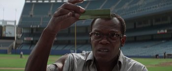 Movie still from “Die Hard with a Vengeance” (1995), directed by John McTiernan – A person holding up a piece of paper; Close Up shot, Low angle