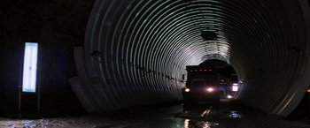 Movie still from “Die Hard with a Vengeance” (1995), directed by John McTiernan – A train traveling down a train track in a tunnel; Extreme Wide shot, Low angle