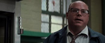 Movie still from “Die Hard with a Vengeance” (1995), directed by John McTiernan – A person wearing a suit and tie; Close Up shot, Low angle