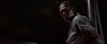Movie still from “Die Hard with a Vengeance” (1995), directed by John McTiernan – A man with blood all over his face and neck; Close Up shot, Low angle