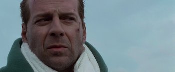 Movie still from “Die Hard with a Vengeance” (1995), directed by John McTiernan – A person with a towel around his neck; Close Up shot, Low angle