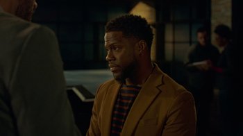 Movie still from “Die Hart” (2023), directed by Eric Appel – A person wearing a jacket; Medium shot, Over the shoulder angle