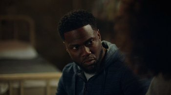 Movie still from “Die Hart” (2023), directed by Eric Appel – A person sitting down with his eyes wide open; Close Up shot, Over the shoulder angle