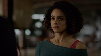 Movie still from “Die Hart” (2023), directed by Eric Appel – A person wearing a green and red shirt; Close Up shot, Over the shoulder angle