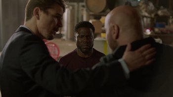 Movie still from “Die Hart” (2023), directed by Eric Appel – Three men are standing in front of each other; Medium shot, Over the shoulder angle