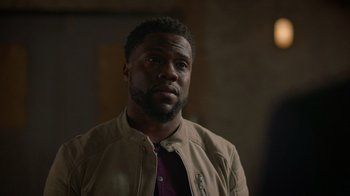 Movie still from “Die Hart” (2023), directed by Eric Appel – A person wearing a jacket; Close Up shot, Over the shoulder angle