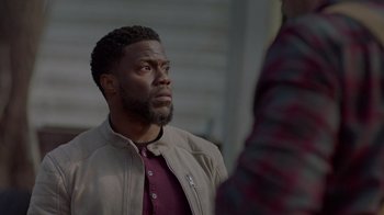 Movie still from “Die Hart” (2023), directed by Eric Appel – A person wearing a jacket; Close Up shot, Over the shoulder angle