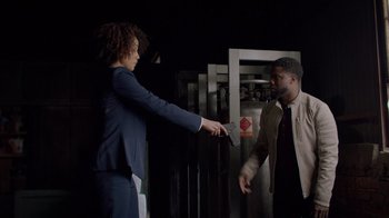 Movie still from “Die Hart” (2023), directed by Eric Appel – Two people in a room one is holding a knife and the other is holding a knife; Medium shot, Over the shoulder angle