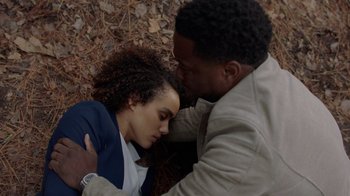 Movie still from “Die Hart” (2023), directed by Eric Appel – A man and a woman laying on the ground together; Close Up shot, Overhead angle