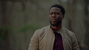 Movie still from “Die Hart” (2023), directed by Eric Appel – A person wearing a jacket; Close Up shot, Over the shoulder angle